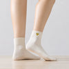 Chaussette haute chaude avec cœur doré brodé.
