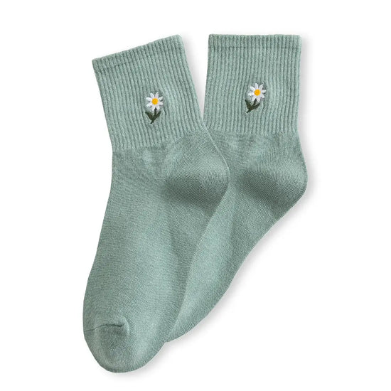 Chaussette haute unie avec marguerite brodée.