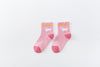 Chaussettes montantes, fond rose, motif  licornes. Pour bébé et enfant (du 12 mois au 12 ans).