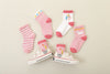 Lot de 5 chaussettes montantes, fond rose ou blanc, motifs variés : rayures, licornes, coeurs. Pour bébé et enfant (du 12 mois au 12 ans).