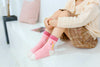 Chaussettes montantes, fond rose, motif : licornes. Pour bébé et enfant (du 12 mois au 12 ans).