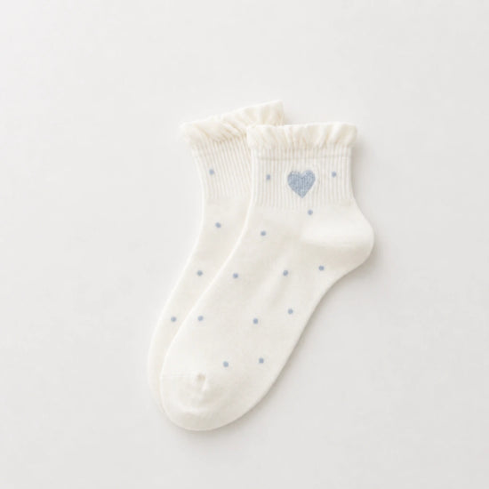 Chaussettes Volant Cœur & Pois femme vendues à l’unité. Modèles blanc à pois bleus ou gris bleu avec volant et cœur brodé. Taille unique 35-41.