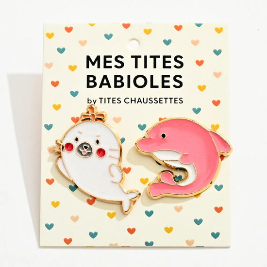 Lot de 2 pin's phoque blanc et dauphin rose.