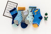 Lot de 5 chaussettes enfant bleues à motifs dinosaures. Confortables, douces et ludiques. Tailles de 12 mois à 12 ans. Parfait pour les petits explorateurs.